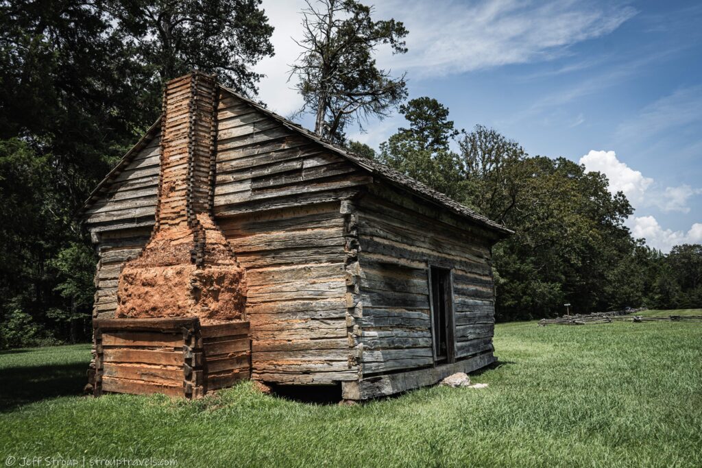 A log cabin stands at the end of one of Shiloh Trails.